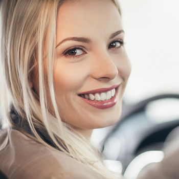 A woman smiling while driving