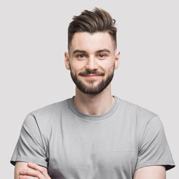 A young man with gray t-shirt on a gray background smiling